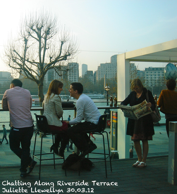 Close up of People relaxing on Riverside Terrace with a drink 